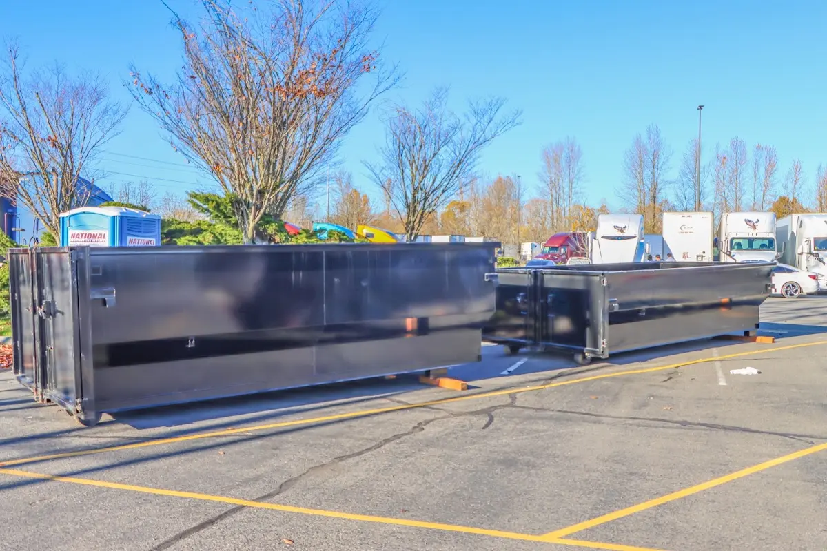 Professional dumpster rental service with roll-off container on residential driveway in Allegheny